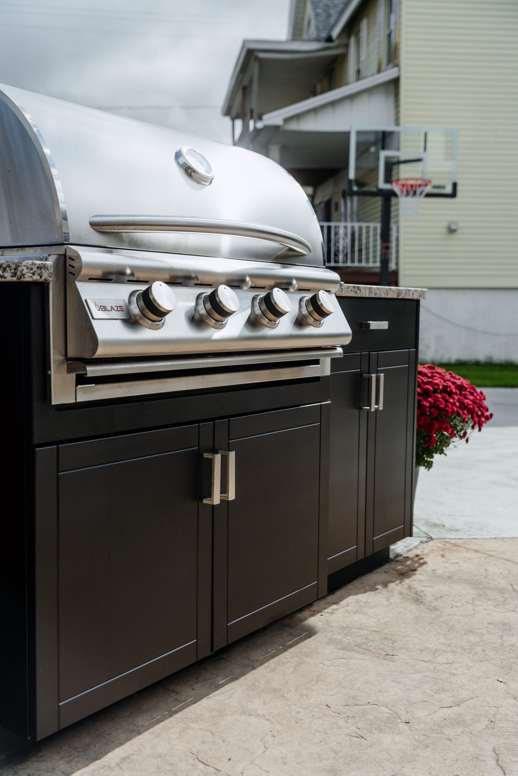 Open Air Cabinetry October Outdoor grill station with dark cabinetry with silver hardware