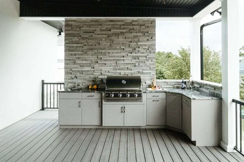 an outdoor kitchen placed on a porch