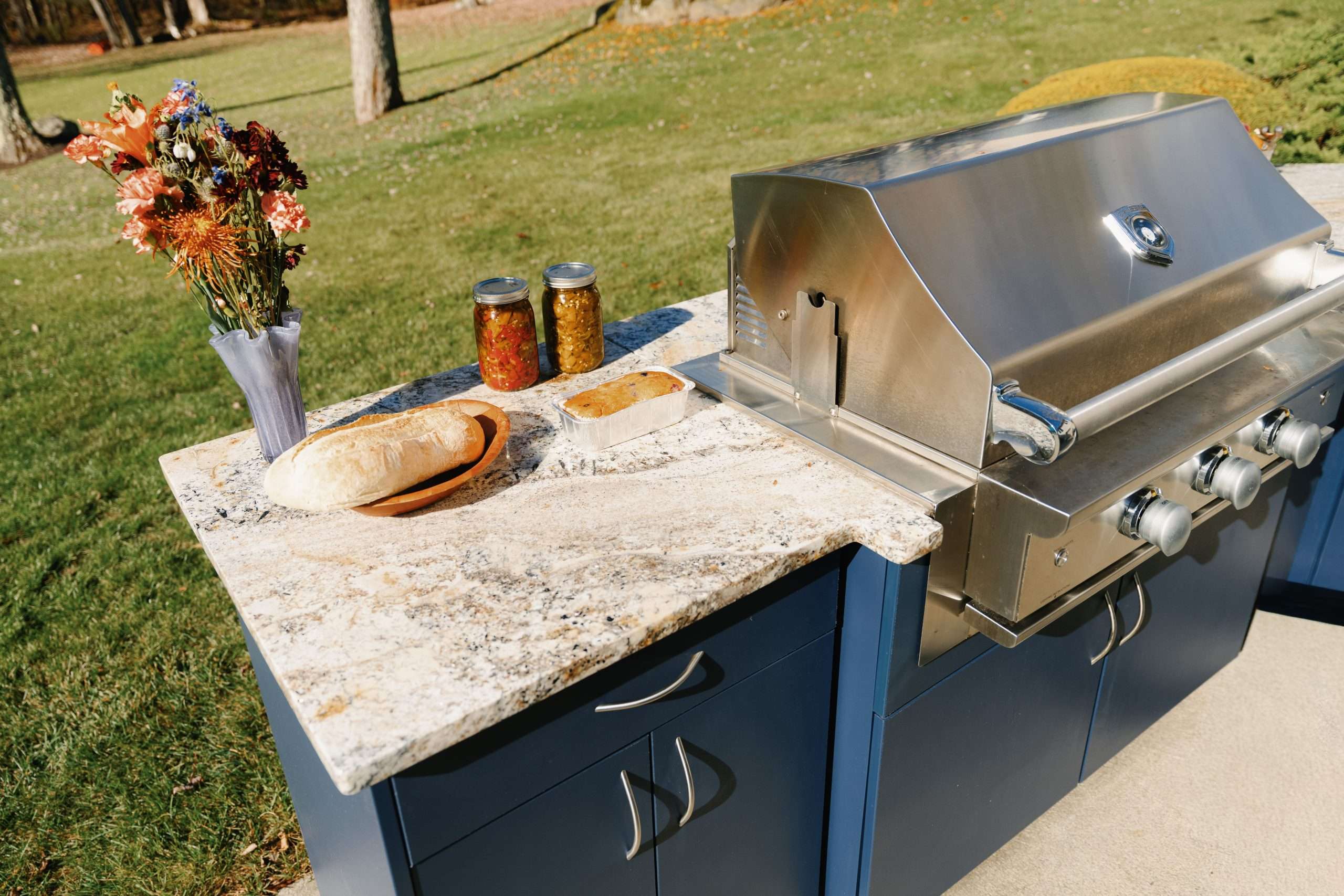 PfcuzS5U close up of outdoor kitchen countertop with grill and food